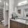 Large well lit bathroom with white accents 