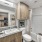 Large well lit bathroom with white accents 