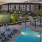 pool area with reclining seats and landscaping