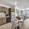 Spacious and well lit kitchen with wood flooring and stainless steel appliances