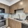 Spacious and well lit kitchen with wood flooring and stainless steel appliances