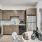Spacious and well lit kitchen with wood flooring and stainless steel appliances