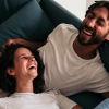 lifestyle image of two people laughing and lounging
