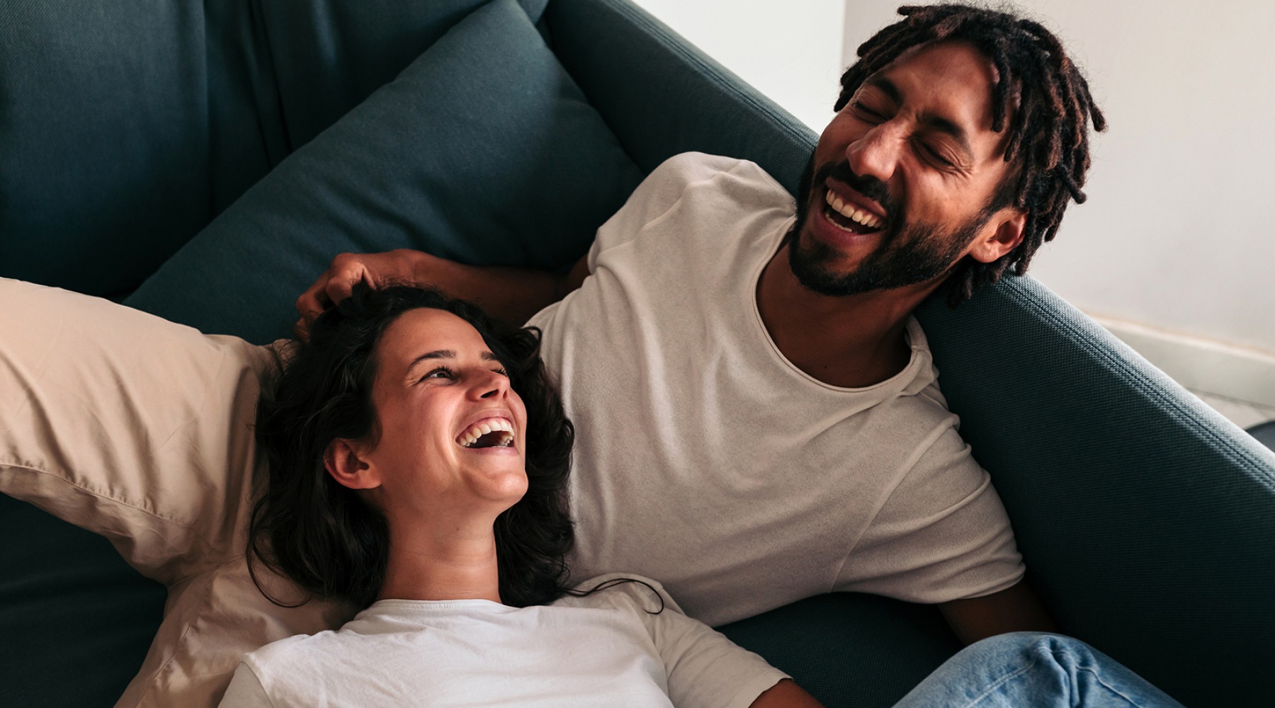 The Art of Living lifestyle image of two people laughing and lounging